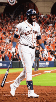 a baseball player for the astros holds his bat