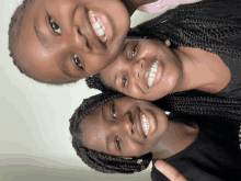 three young girls are posing for a picture together and smiling for the camera