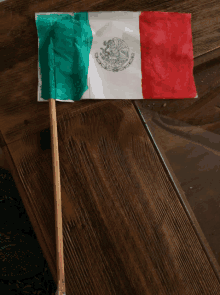 a small mexican flag with a wooden stick