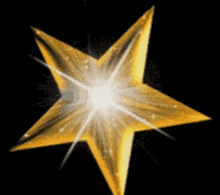 a gold star with a light coming out of the center