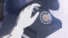 a person 's hand is pressing a button on a black telephone