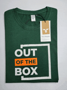 a green t-shirt with out of the box written on it