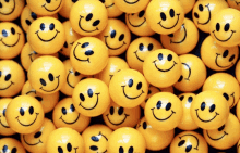 a bunch of yellow smiley faces are stacked together