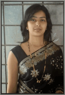 a woman wearing a black and gold floral saree