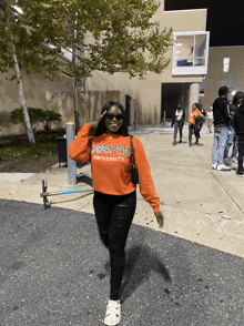 a woman wearing an orange morgan state university shirt