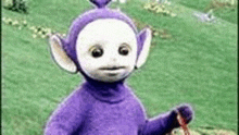 a purple and white teletubbies doll is standing in a field holding a red rope .