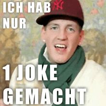 a man wearing a hat and scarf with the words ich hab nur 1 joke gemacht below him