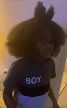 a young boy wearing a t-shirt that says boy on it