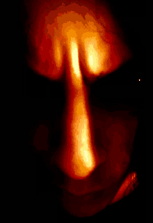 a close up of a person 's face with a bright orange nose