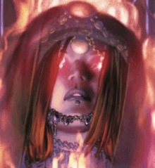 a close up of a woman 's face with flames coming out of her eyes