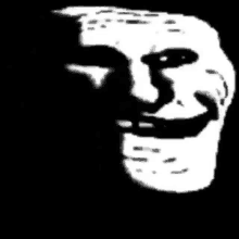 a black and white image of a troll face with a smile on it .