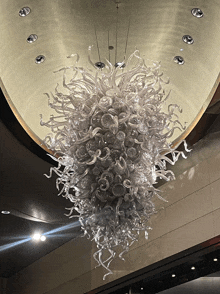 a large glass chandelier hangs from the ceiling of a room