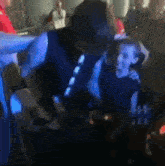 a blurry picture of a man and a boy dancing in a dark room