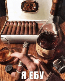 a man smoking a cigar next to a bottle of remy martin