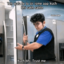 a man in a blue shirt is opening a refrigerator door with a caption that says trust me