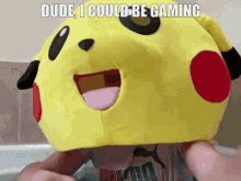 a person wearing a pikachu hat with the words dude i could be gaming written on it