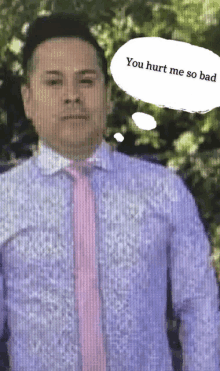 a man in a purple shirt and pink tie has a thought bubble that says " you hurt me so bad "