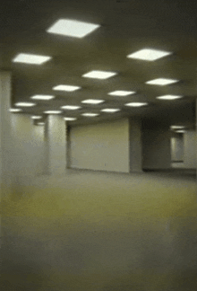 an empty hallway with a lot of lights on the ceiling