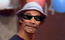 a close up of a man wearing sunglasses and a hat .