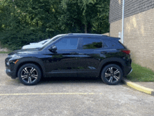 a black suv is parked on the side of the road