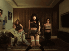 three women are standing in a living room with a couch