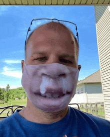 a bald man wearing a face mask with a funny face on it .