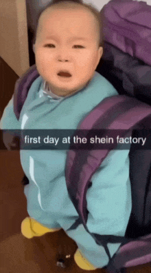 a baby is sitting in front of a purple backpack with the words first day at the shein factory on the bottom