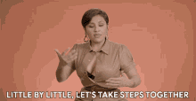 a woman says " little by little let 's take steps together " in sign language