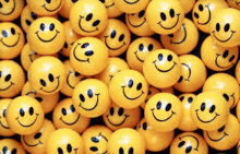 a pile of yellow smiley faces sitting on top of each other on a table .