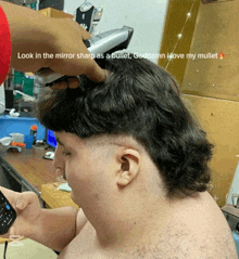 a man with a mullet is getting his hair cut by another man