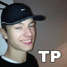 a young man wearing a black hat and smiling with the word tp written on the bottom .