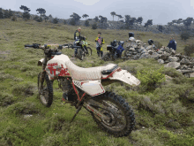 a yamaha dirt bike is parked in a field