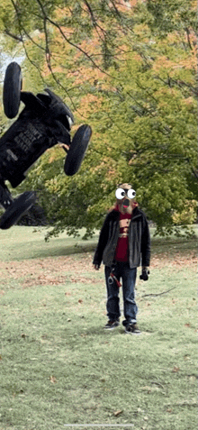 a man with googly eyes is standing in front of a buggy that says " don 't touch the buggy " on it