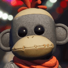 a stuffed monkey wearing a scarf and a sock on its head