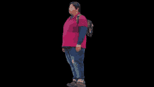 a man with a backpack on his back is wearing a pink shirt