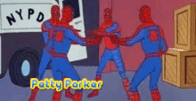 a group of spider-men are standing next to each other in front of a nypd truck .