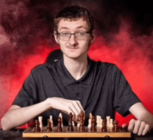 a man is playing a game of chess with smoke behind him