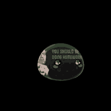 a black button with a picture of a man and the words `` you should be doing homework '' on it .