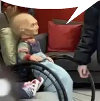 a doll in a wheelchair with a speech bubble behind it