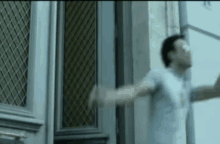 a man with his arms outstretched in front of a door