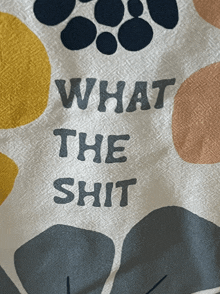 a shirt that says what the shit with circles in the background