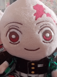 a close up of a stuffed toy with a red eye