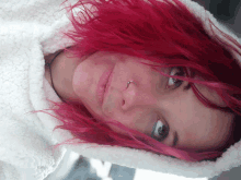 a woman with red hair and a nose ring is wearing a white hoodie