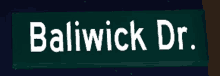 a street sign for baliwick dr. against a dark sky