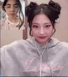 a girl wearing a daisy sweatshirt talks to another girl on a video call