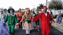 a group of people dressed in costumes holding hands