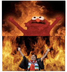 a woman is standing in front of a fire and elmo is behind her