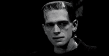 a black and white photo of frankenstein , the monster from the movie frankenstein , looking at the camera .