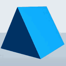 a blue pyramid is sitting on a gray surface .