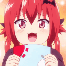 a girl with red hair is holding a piece of paper and making a face